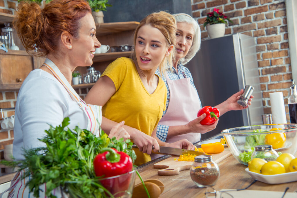 grandmother mother daughter cooking healthy in kitchen