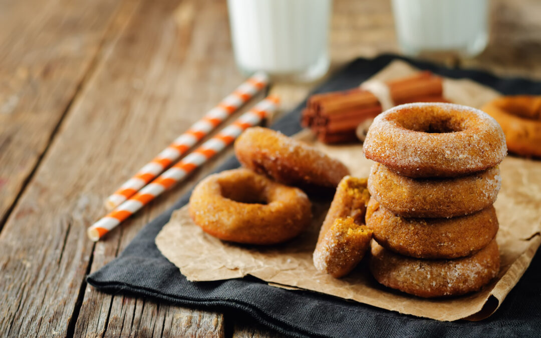 baked pumpkin donuts with glasses of milk