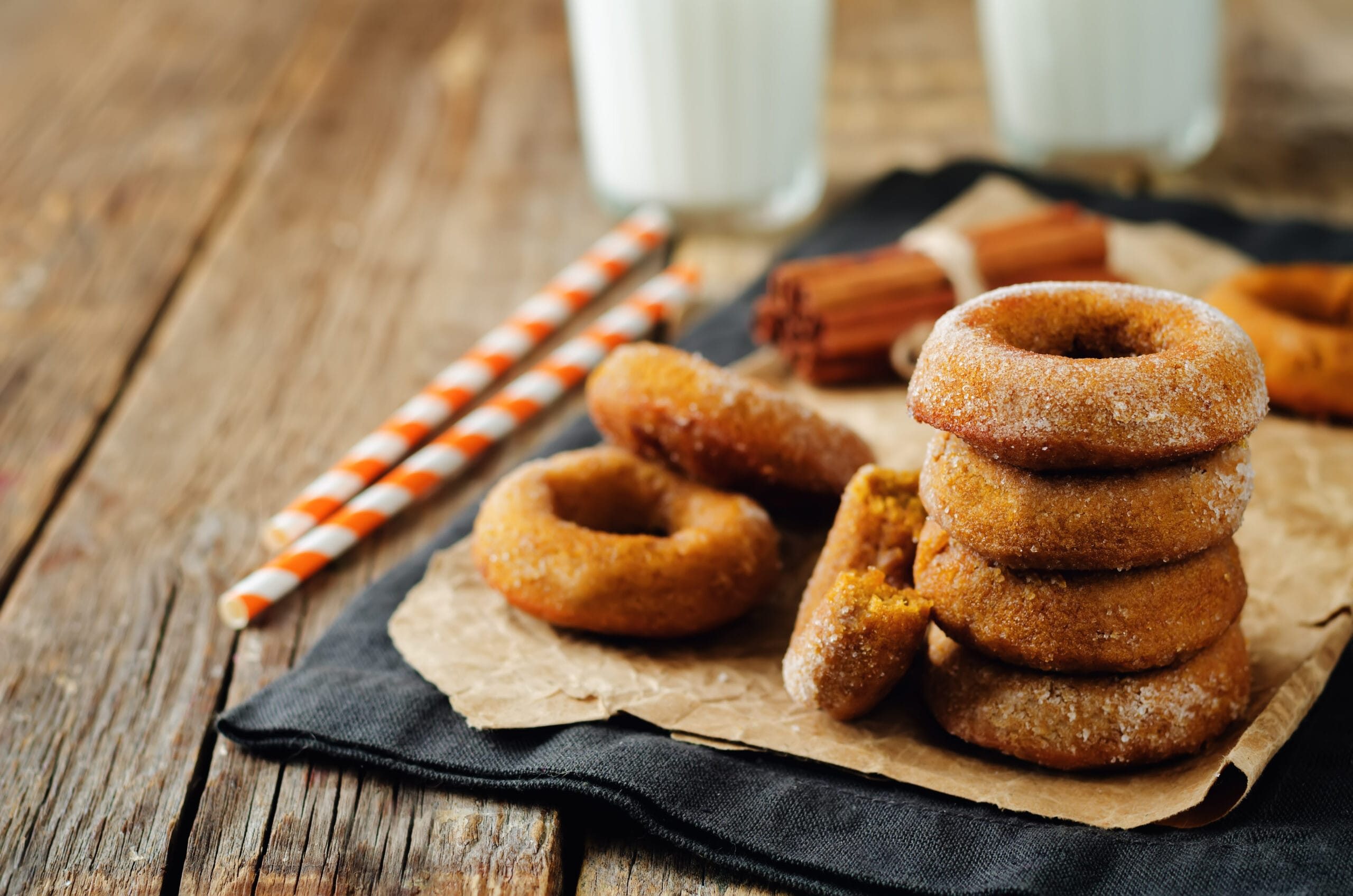 high carb and sugar baked pumpkin donuts with glasses of milk