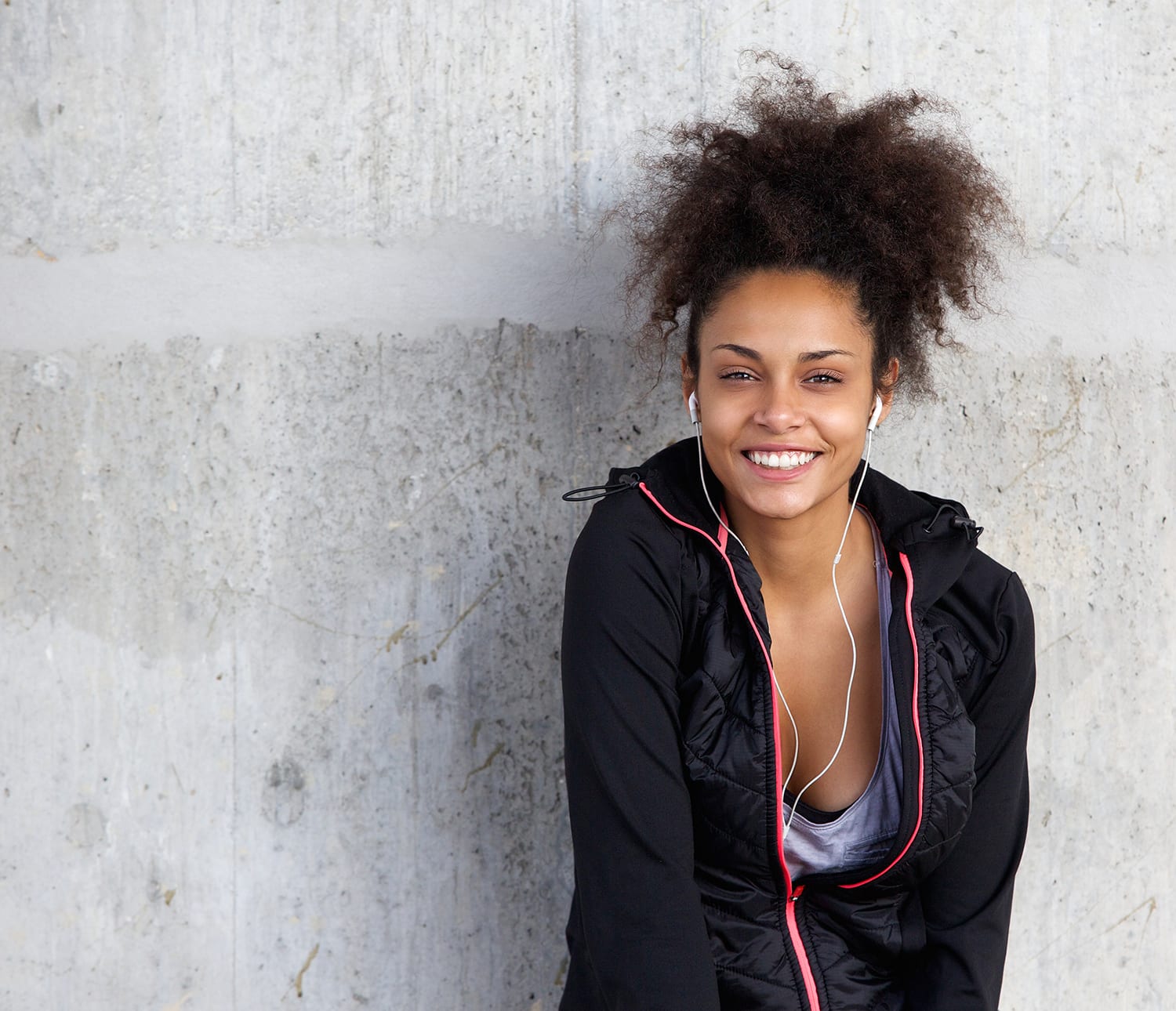 Cheerful Young Woman Listening To Music With Earphones