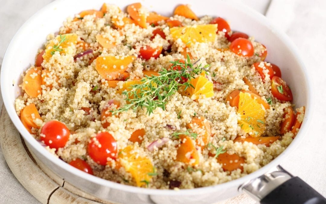 quinoa bowl with tomatoes and orange slices