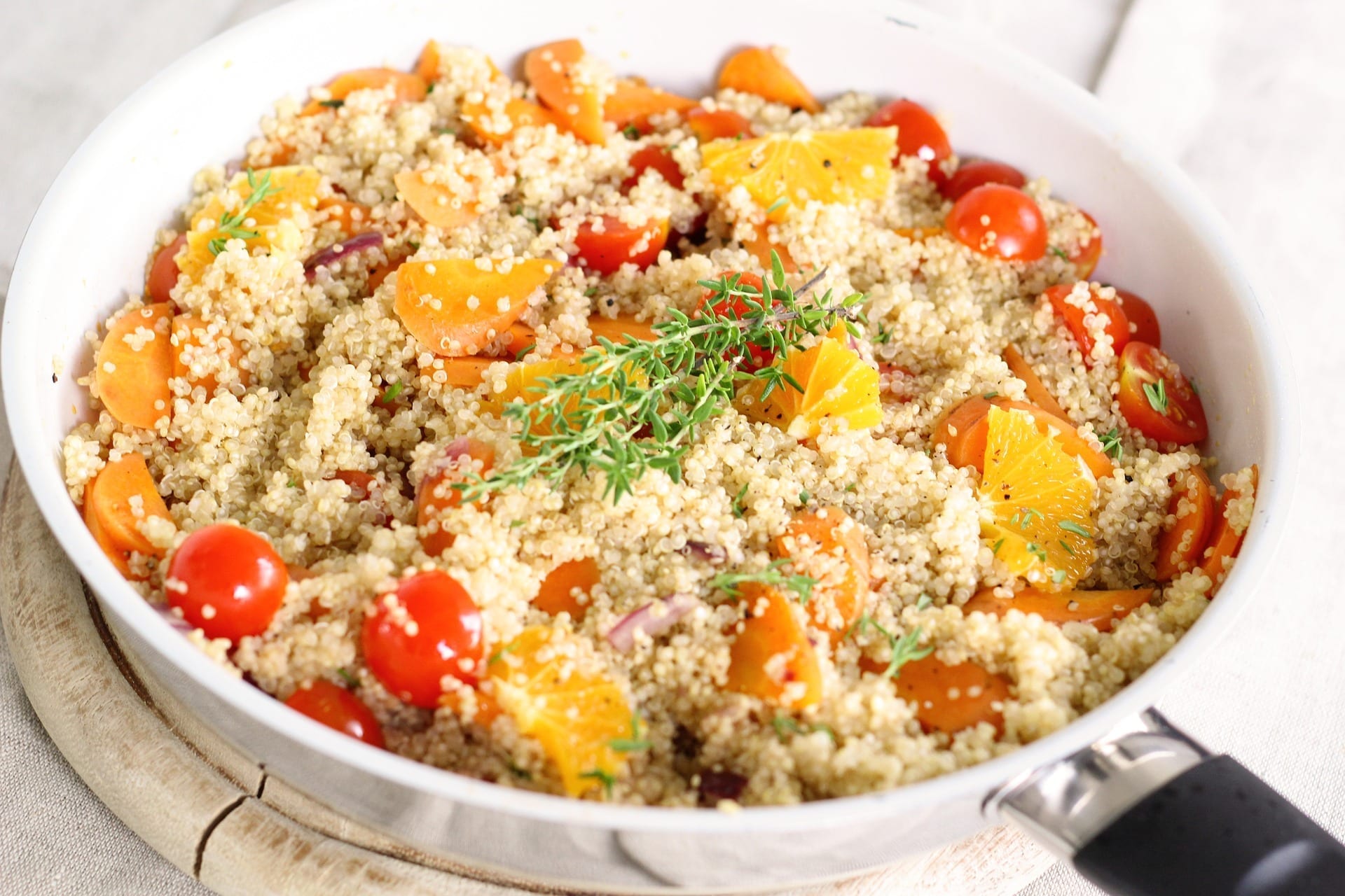 quinoa bowl with tomatoes and orange slices