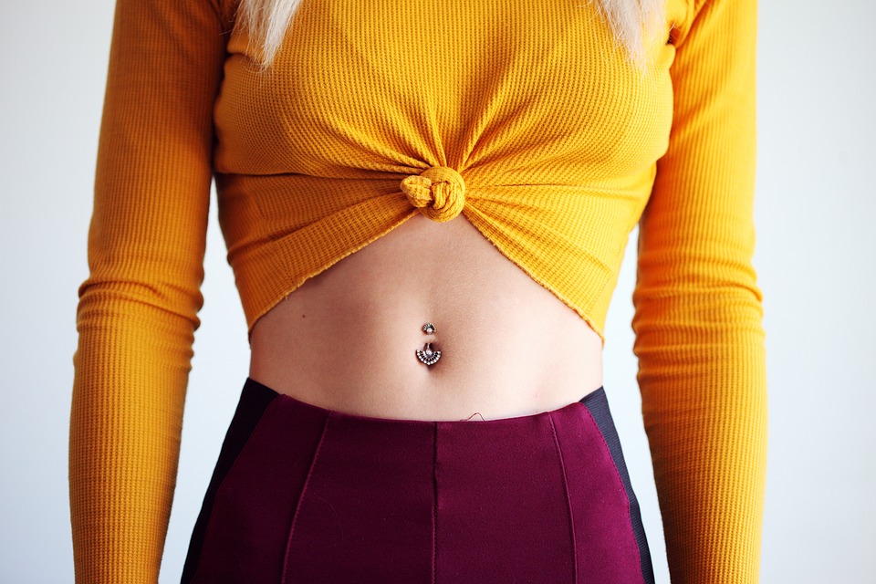 young womans stomach with belly ring