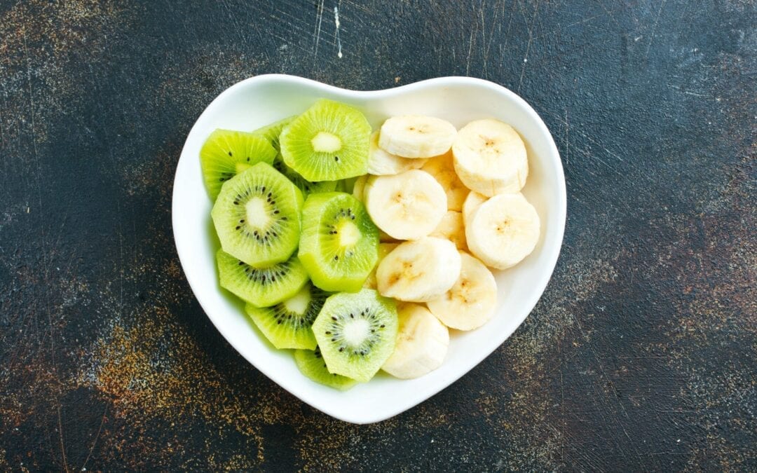 kiwis and bananas in a heart-shaped bowl