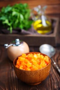 Pumpkin pulp pieces in a wooden dish