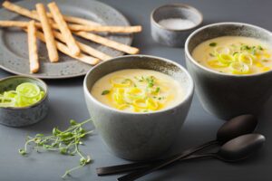 Two bowls of potato soup with leeks
