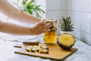 Woman fermenting a pineapple kombucha drink