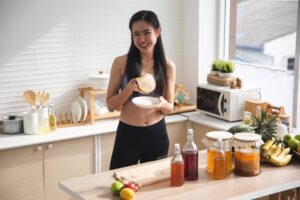 Woman fermenting kombucha in her own kitchen