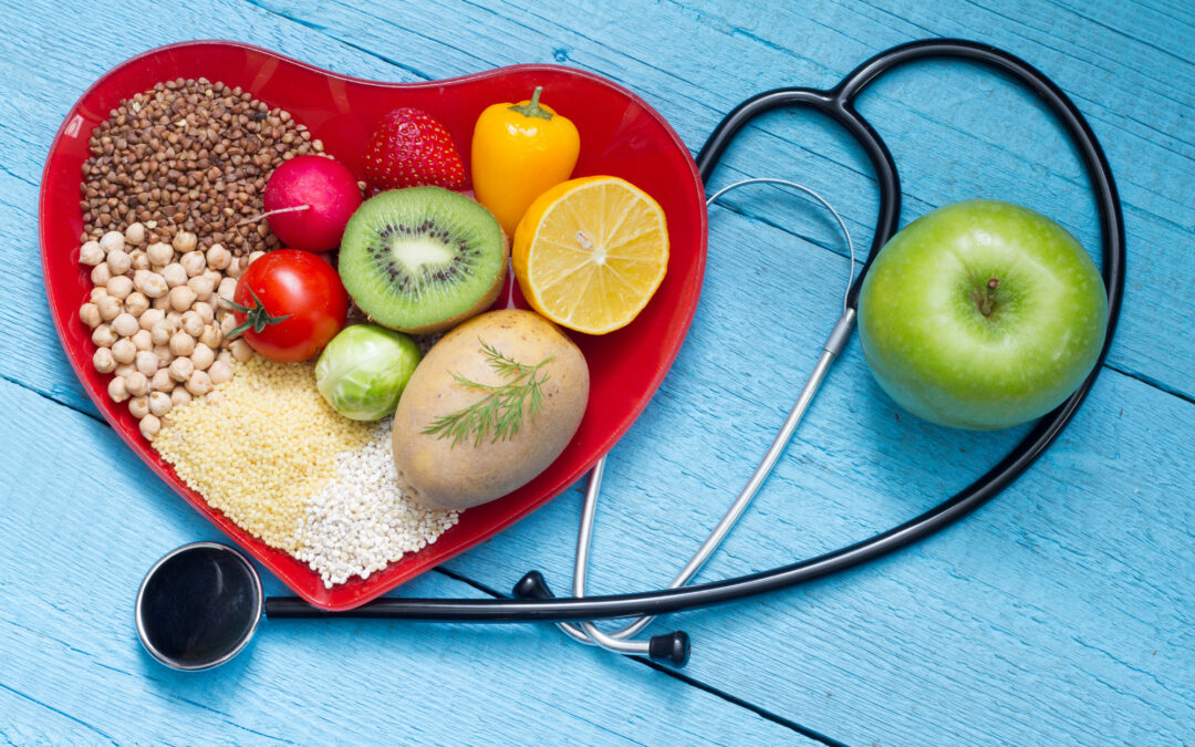 food on heart plate with stethoscope cardiology concept