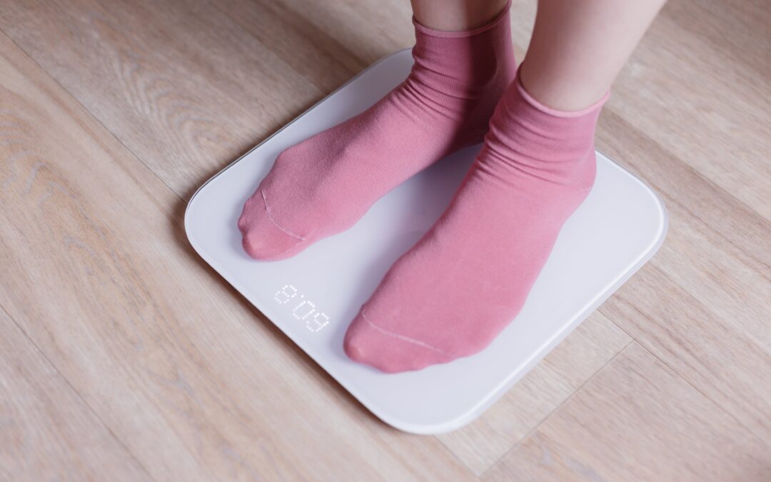 legs_of_a_young_woman_measuring_her_weight_on_scale