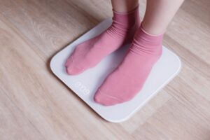 legs of a young woman measuring her weight on a mo 2021 08 26 17 11 08 utc min