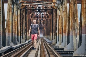traveler walking on railway bridge 2022 02 02 04 50 38 utc min