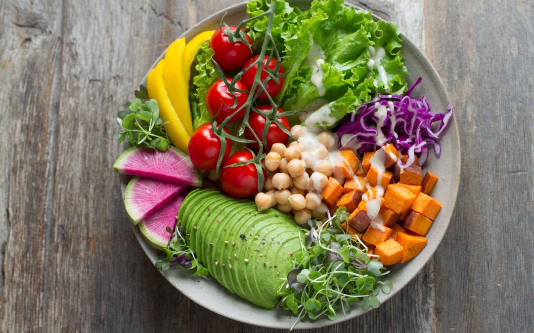 bowl of fresh salad with avocado tomatoes chickpeas and radishes