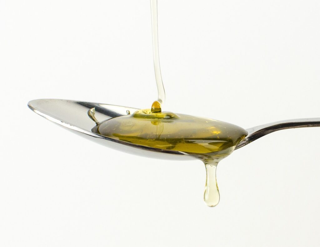 honey being poured on spoon