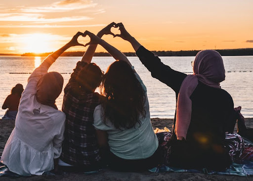 friends watching sunset over water