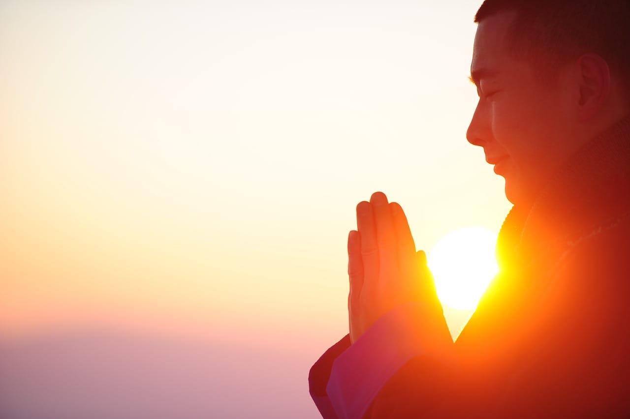 man_meditating_during_sunrise