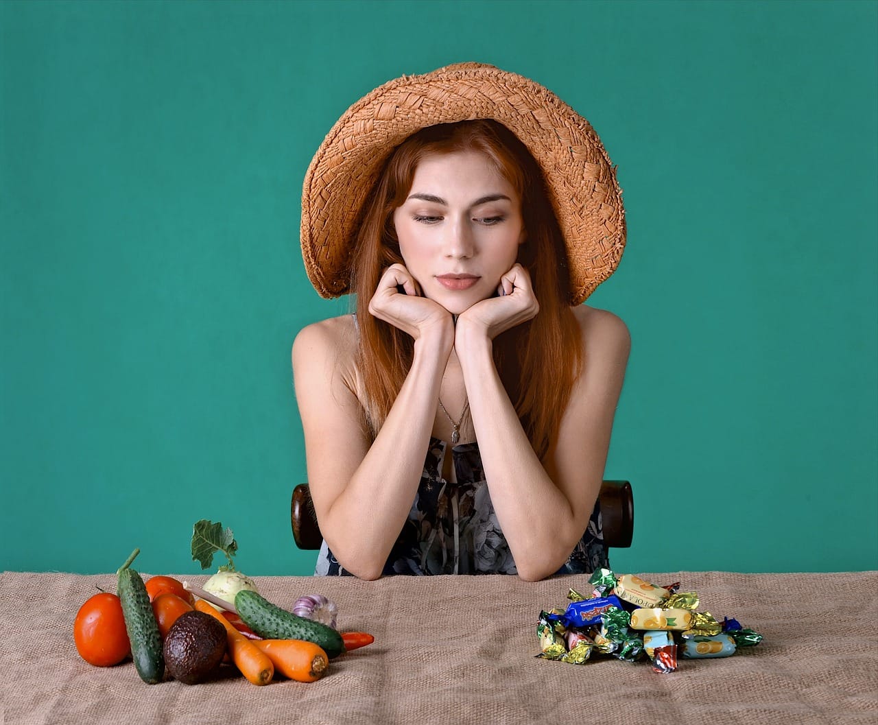 woman_counting_calories_between_vegetables_and_candy