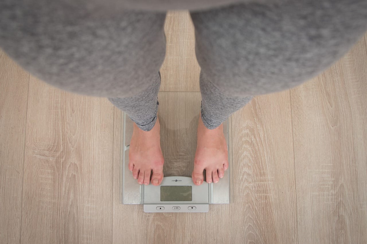 person_on_scale_starting_weight_loss_body_transformation