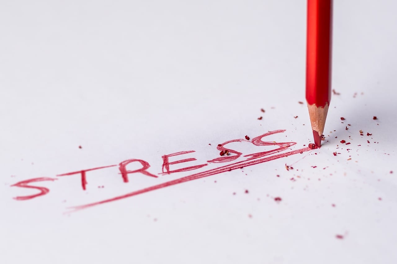 red_pencil_writing_the_word_stressed_on_white_paper