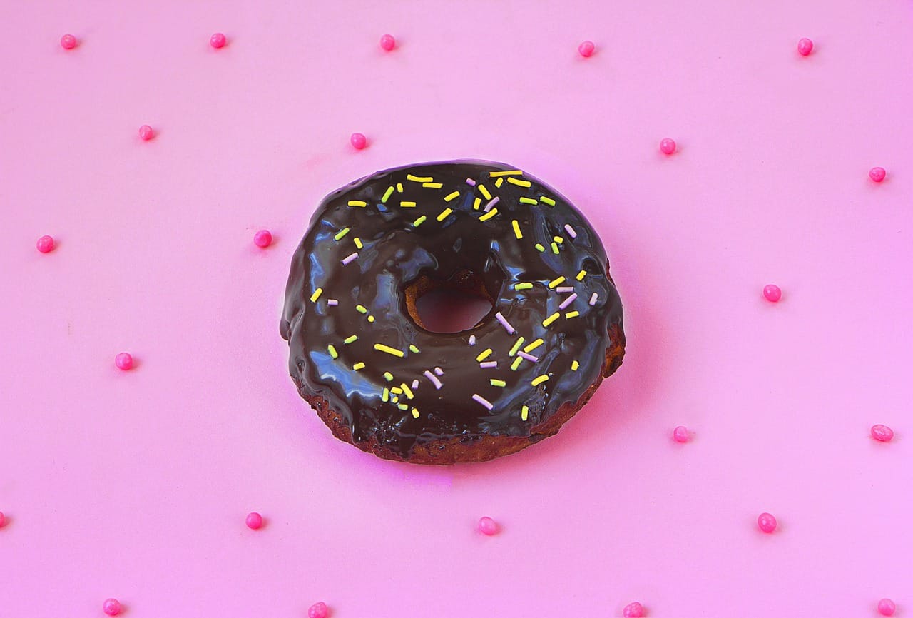 sugary_chocolate_donut_on_pink_background