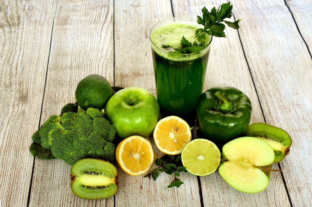 green healthy foods and green juice in a glass