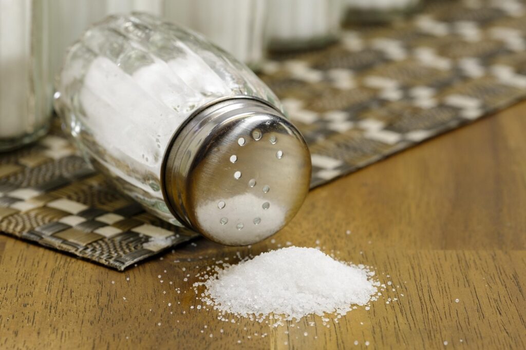 white table salt spilled on table