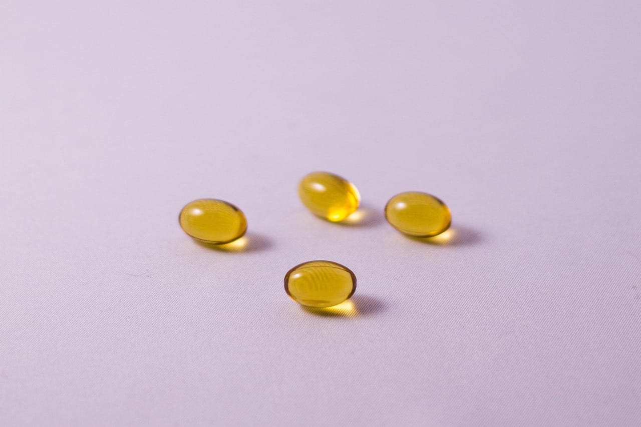 omega 3 capsules on purple background