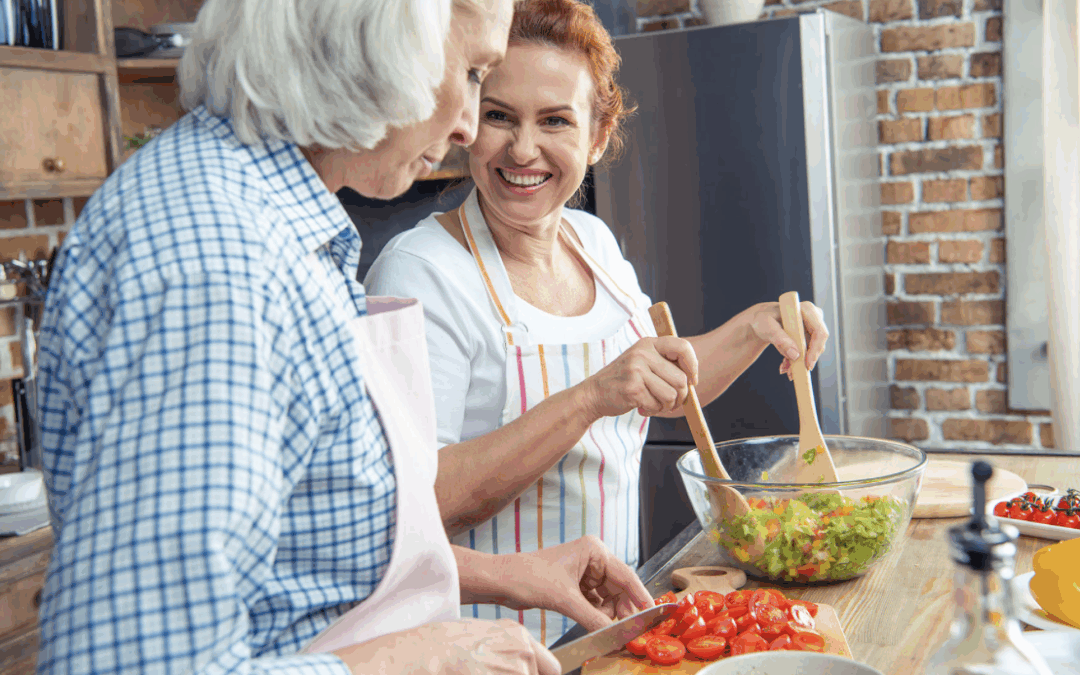 two older women making a salad in kitchen