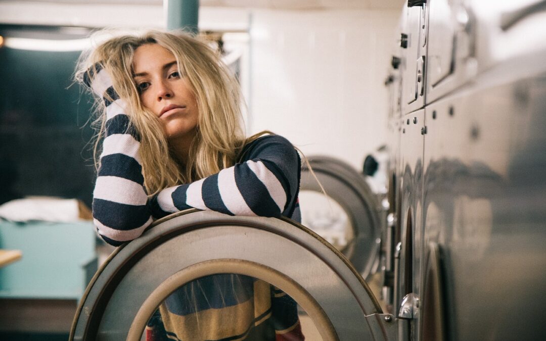 tired woman in laundromat