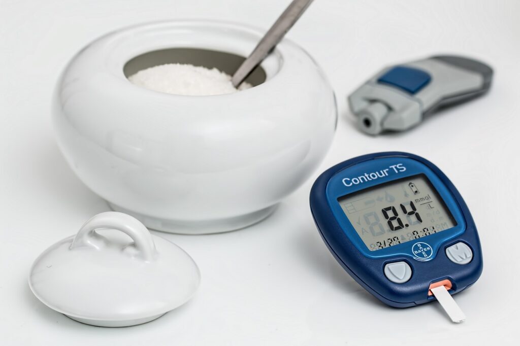 diabetes glucometer and bowl of sugar