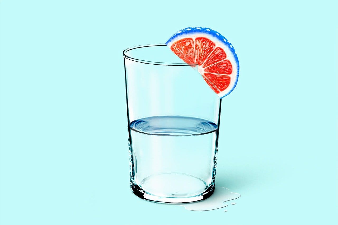 glass of water on light blue background