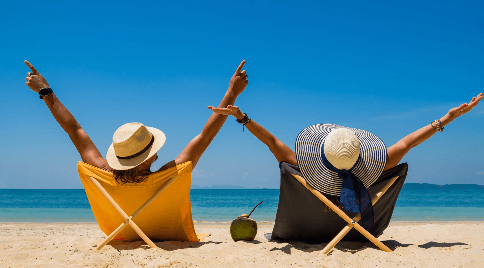 happy couple in beach chairs on the beach