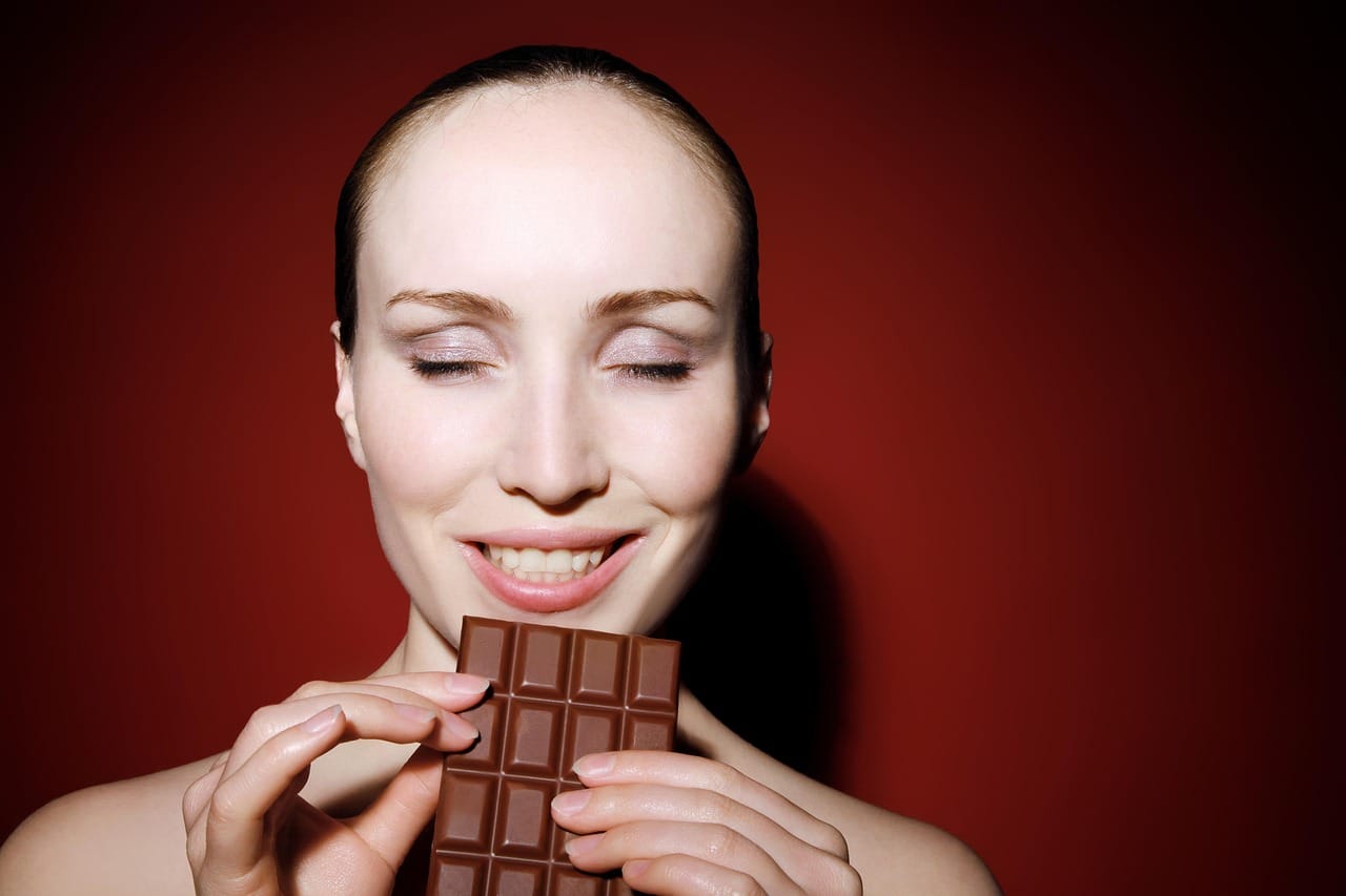 woman eating chocolate bar