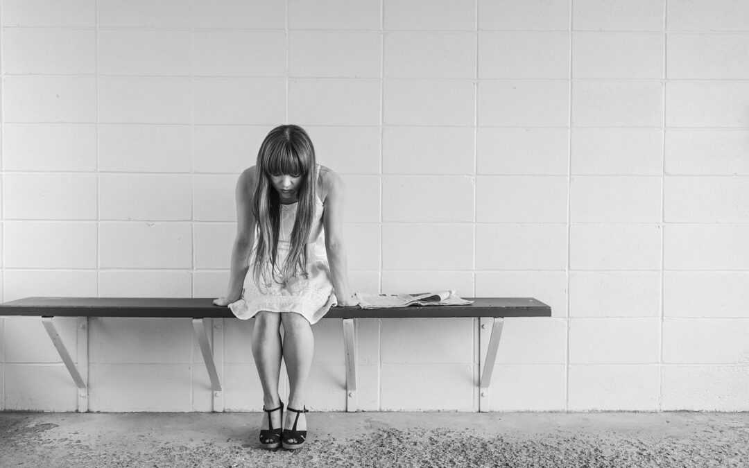 stressed woman sitting on bench