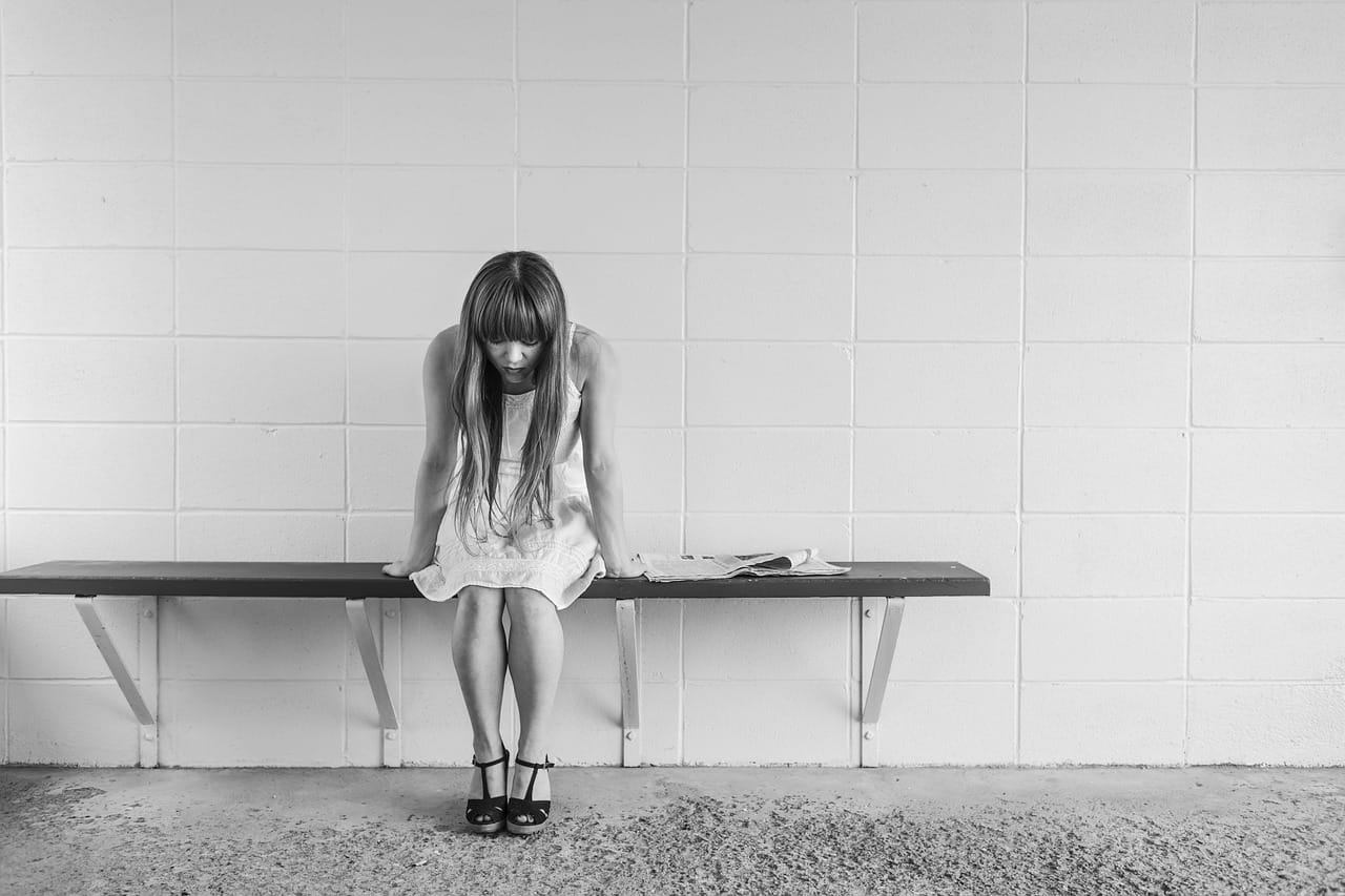 stressed woman sitting on bench