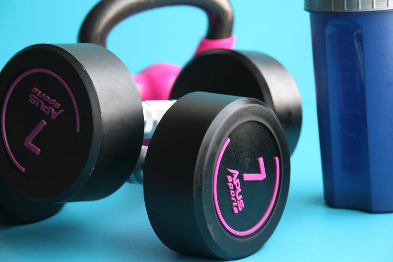 barbell weights for muscle building on blue background