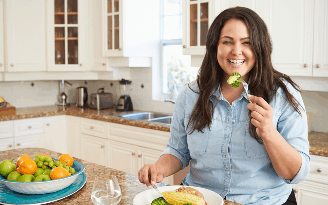 woman eating healthy portioned meal in her kitchen for weight loss